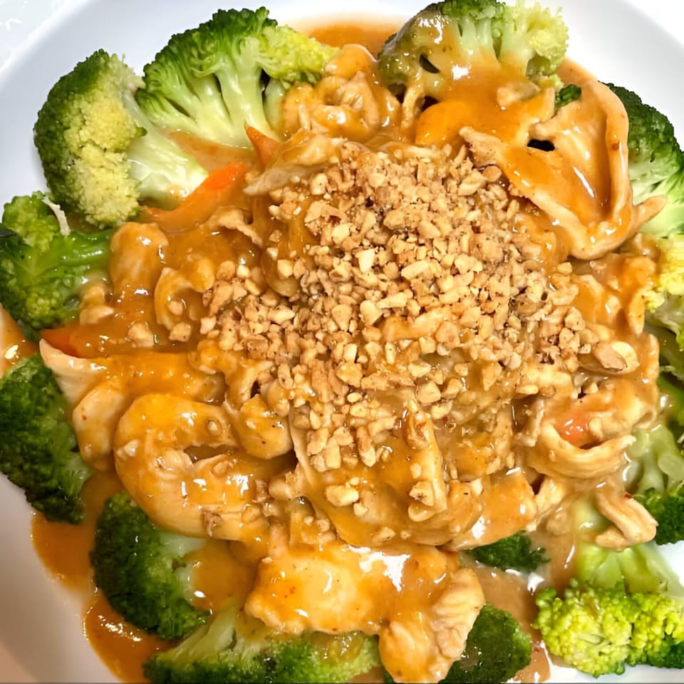 Thai Green House's chicken with peanut sauce, topped with crushed peanuts and surrounded by broccoli.